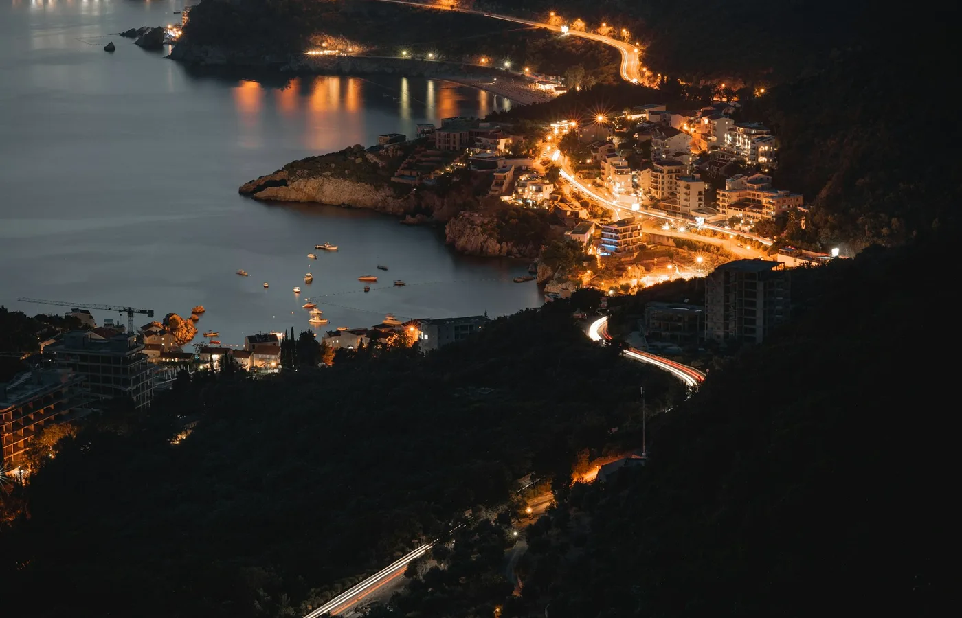 Coastal road lit above the Adriatic at night